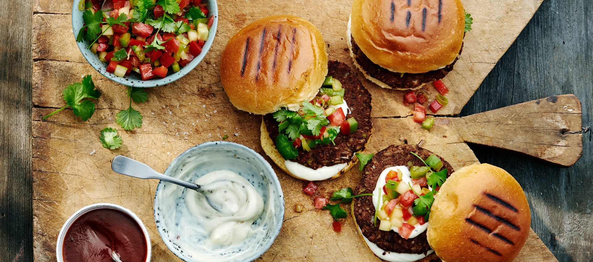 Charcoal grilled Black bean burger with Chilean pebre, vegan aioli & chipotle sauce